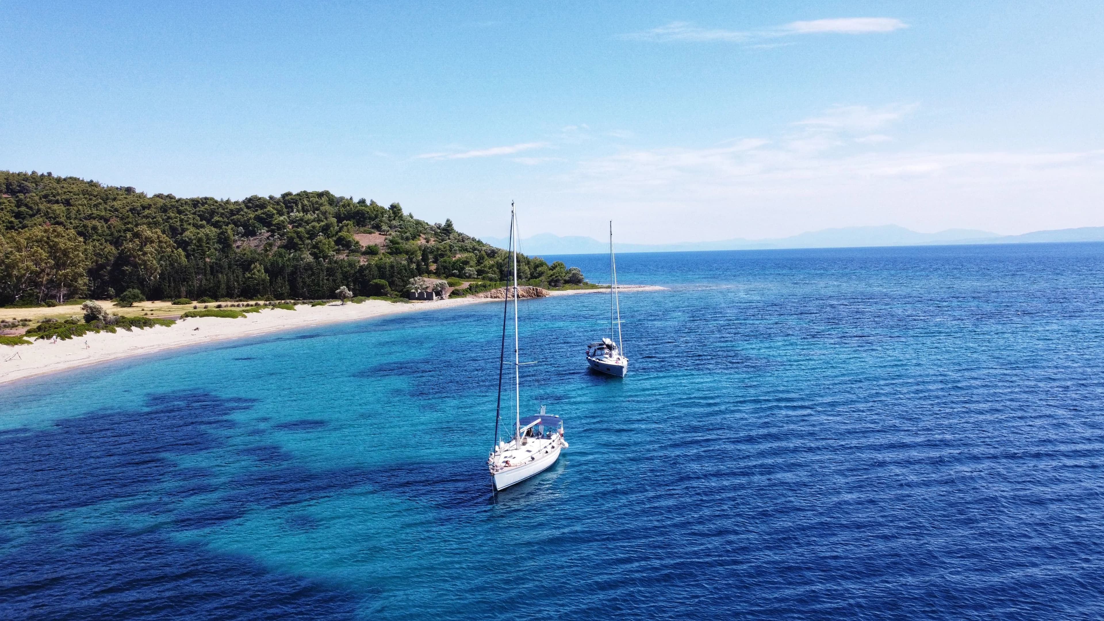 Aerial view of two sailboats on a coastline